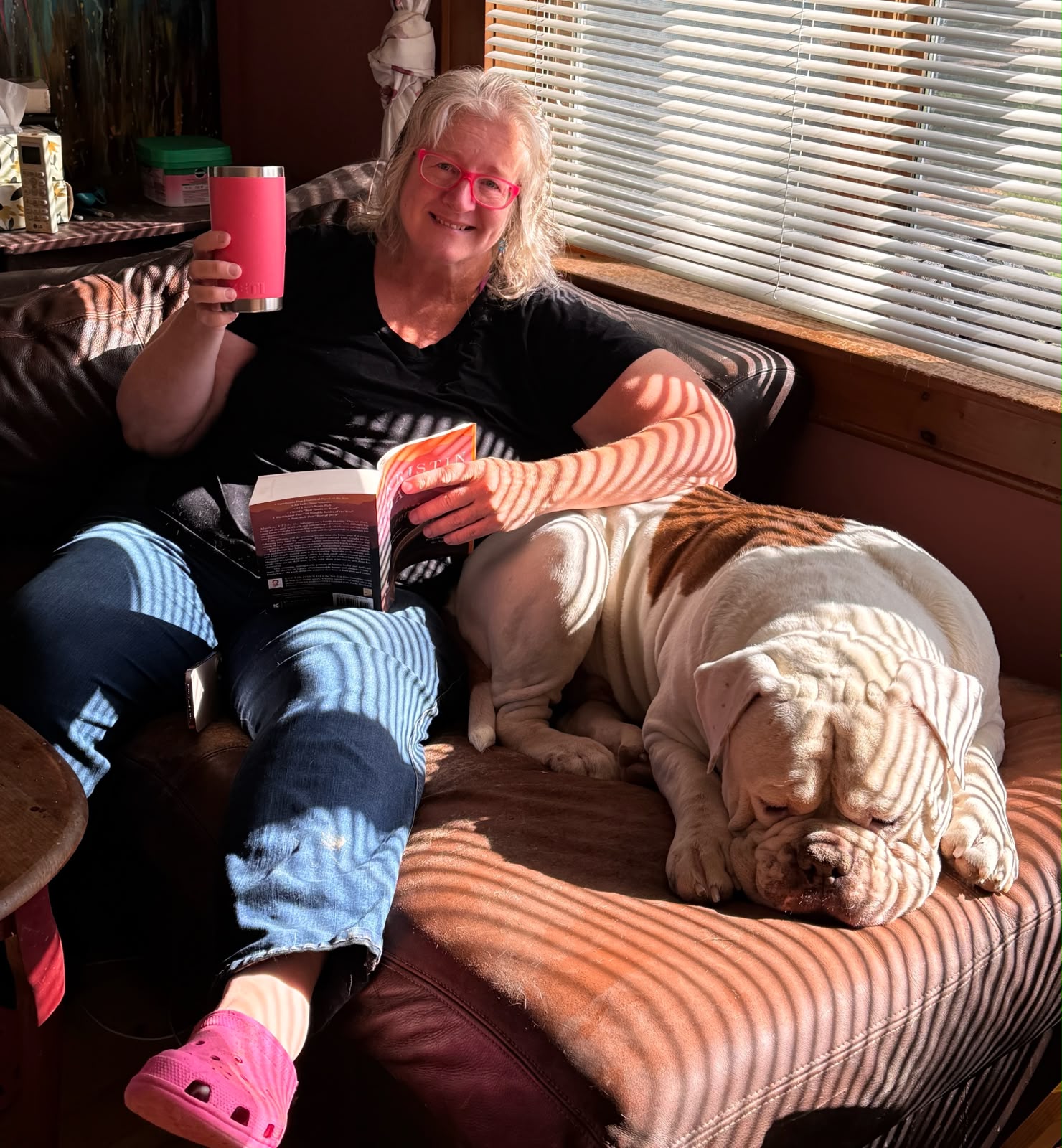 Lesli Rose at home with a sleeping bulldog beside her